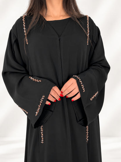 Poignets évasés de l'abaya Nimat bordés de cristaux, finitions couture